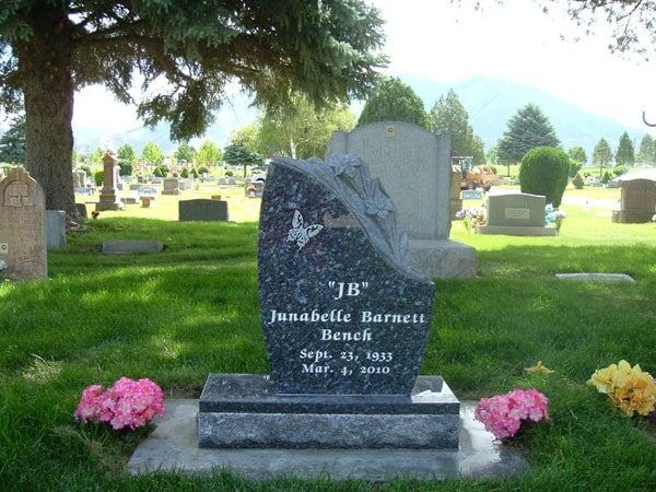 Blue Pearl granite bench memorial with a draped carving