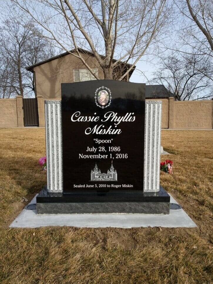 Black granite upright with grey fluted columns and a porcelain cameo