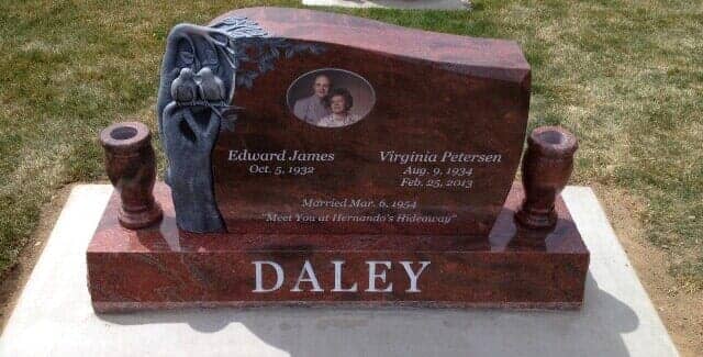 Red granite slant with a carved lily and a colour portrait