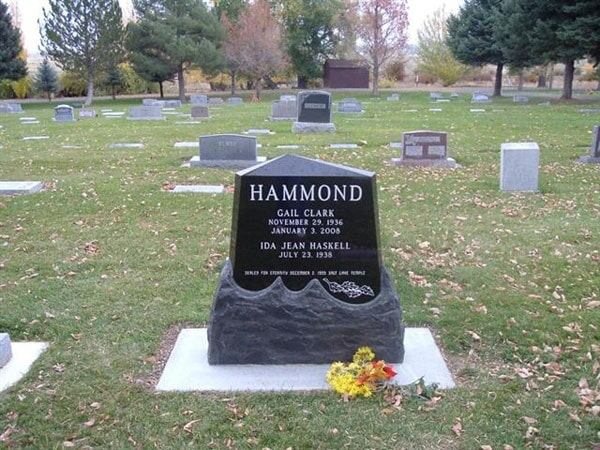 Black granite die set on a carved rough boulder base