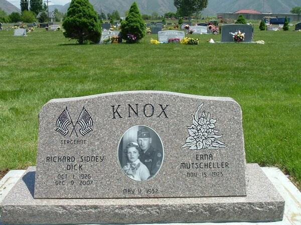 Pink granite companion with crossed flags, a service rank and a porcelain portrait